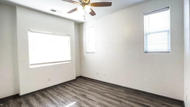 unfurnished room with dark hardwood / wood-style flooring and ceiling fan