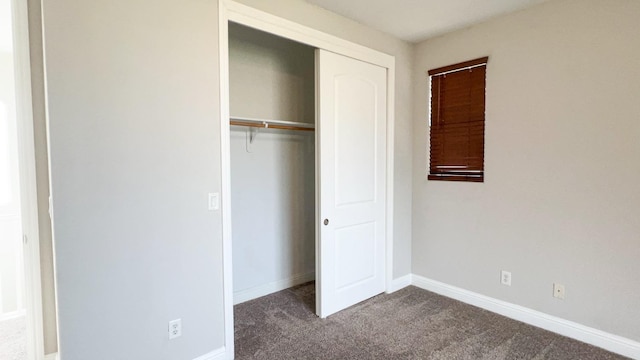 unfurnished bedroom with carpet floors and a closet