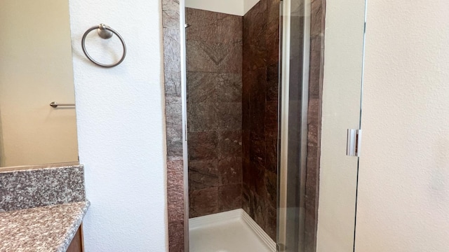 bathroom featuring vanity and an enclosed shower