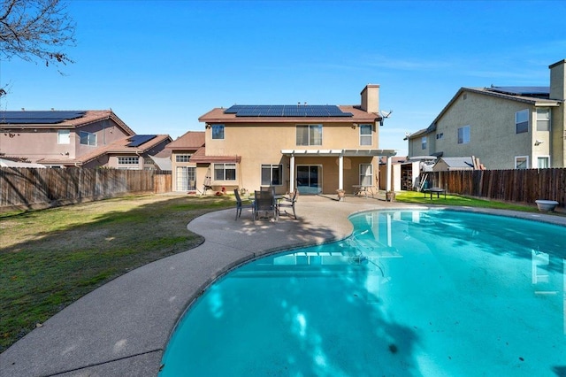 view of swimming pool featuring a lawn and a patio area