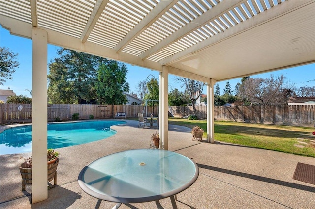 view of pool with a yard, a patio area, and a pergola