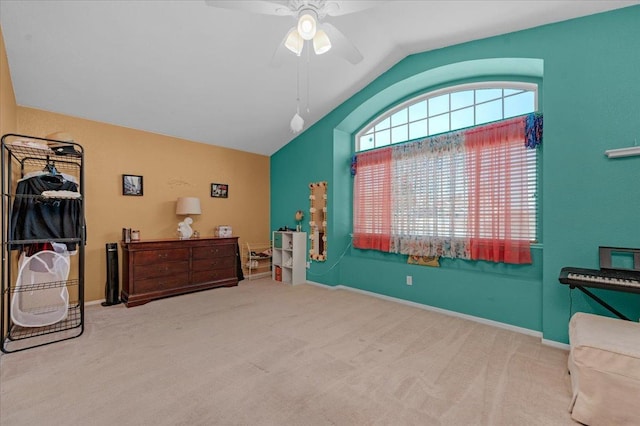 sitting room with lofted ceiling, light colored carpet, and ceiling fan