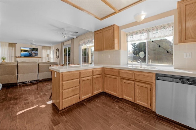 kitchen with dark hardwood / wood-style floors, dishwasher, sink, kitchen peninsula, and light brown cabinets