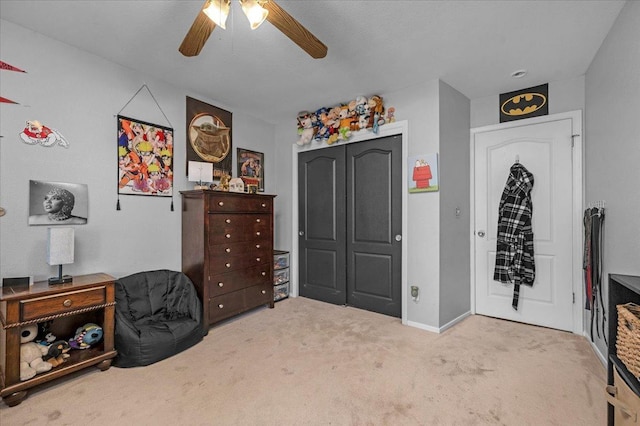 carpeted bedroom with ceiling fan and a closet