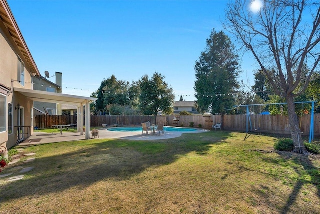 view of yard featuring a fenced in pool and a patio area