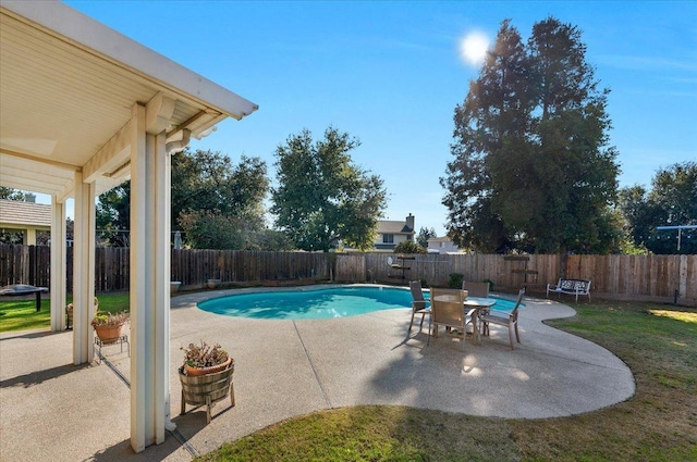 view of swimming pool featuring a lawn and a patio