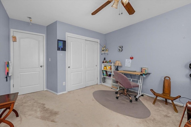 carpeted office space with ceiling fan