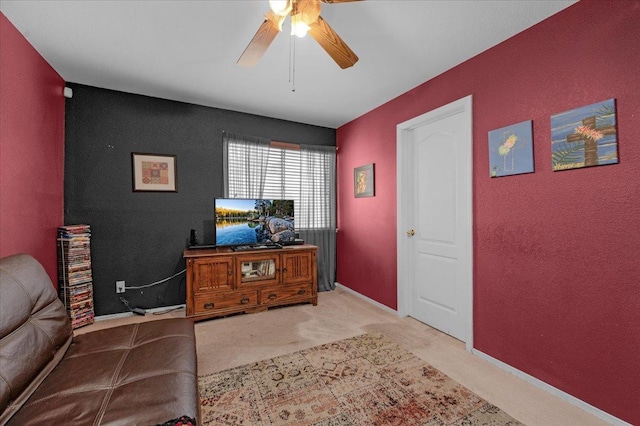 sitting room featuring ceiling fan and light colored carpet