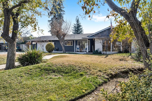 ranch-style home featuring a front yard