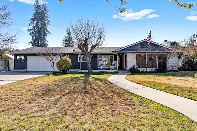 single story home with a garage, a front yard, and covered porch