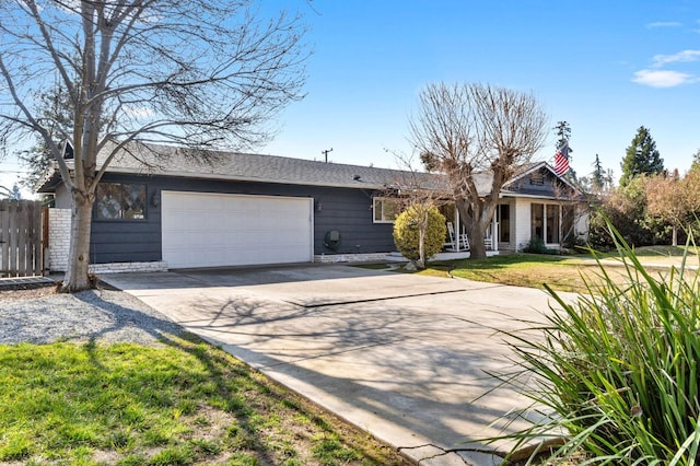 ranch-style house featuring a garage and a front yard