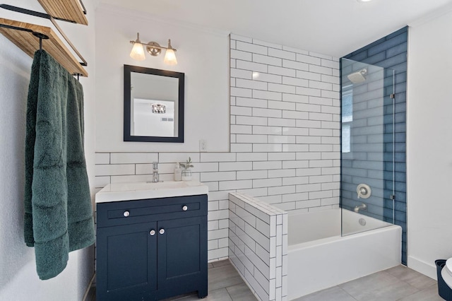 bathroom with vanity, tiled shower / bath combo, tile patterned flooring, and tile walls