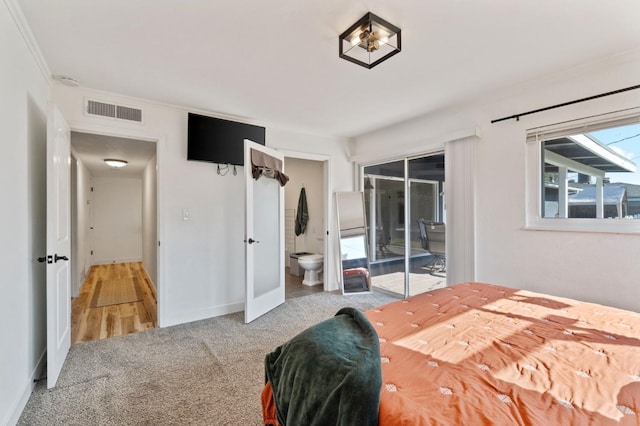 carpeted bedroom with access to exterior, ornamental molding, and ensuite bathroom