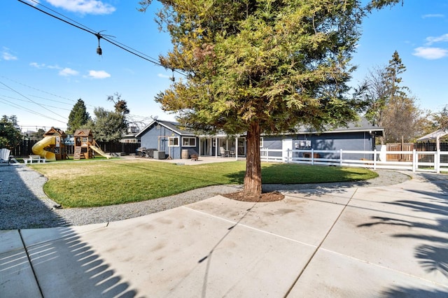 view of front of house with a playground, a patio, and a front lawn