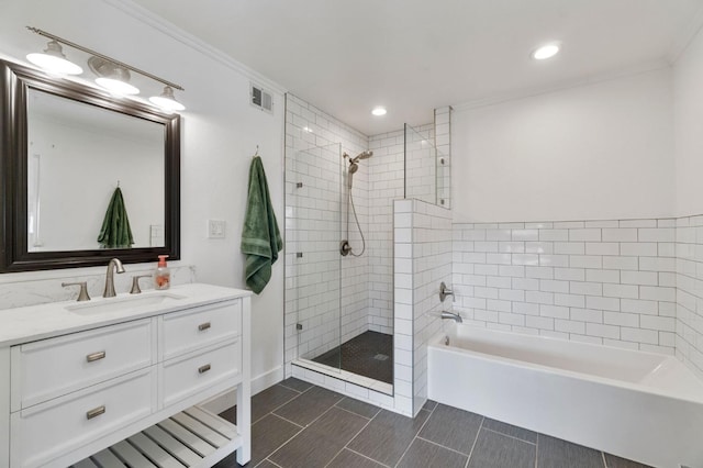 bathroom featuring independent shower and bath, crown molding, and vanity