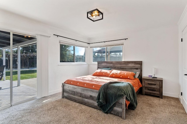 carpeted bedroom with multiple windows, crown molding, and access to exterior