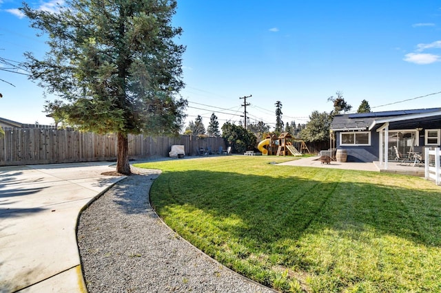 view of yard featuring a playground and a patio area