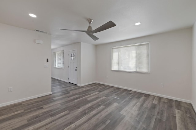 spare room featuring dark hardwood / wood-style floors and ceiling fan