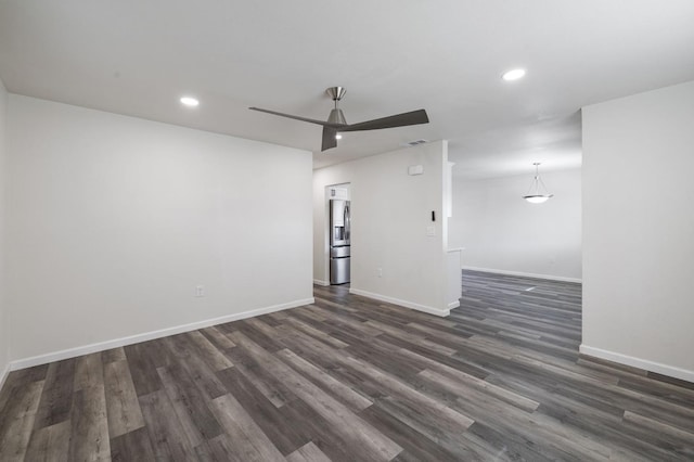 unfurnished room featuring dark wood-type flooring and ceiling fan