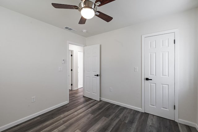 unfurnished bedroom featuring ceiling fan and dark hardwood / wood-style flooring