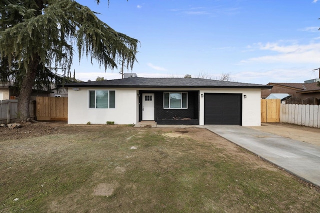 ranch-style home featuring a garage and a front yard