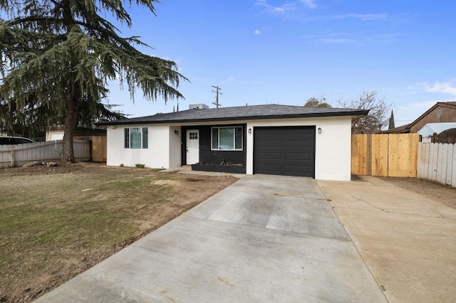 ranch-style home featuring a garage and a front yard