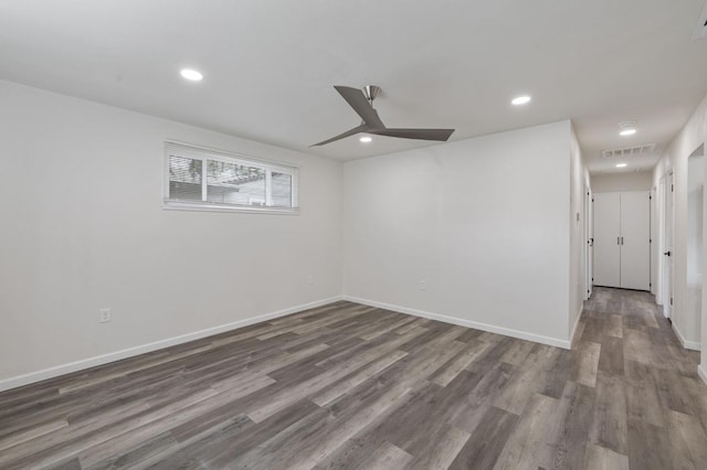 empty room with ceiling fan and hardwood / wood-style floors