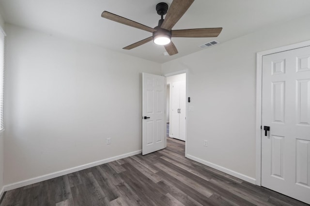 unfurnished bedroom with dark wood-type flooring and ceiling fan