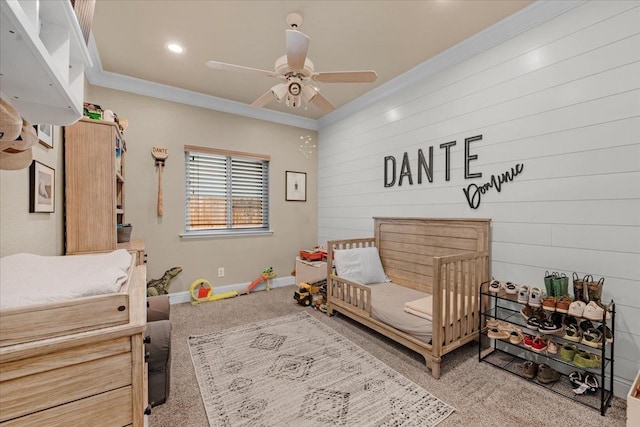 carpeted bedroom with ceiling fan and ornamental molding