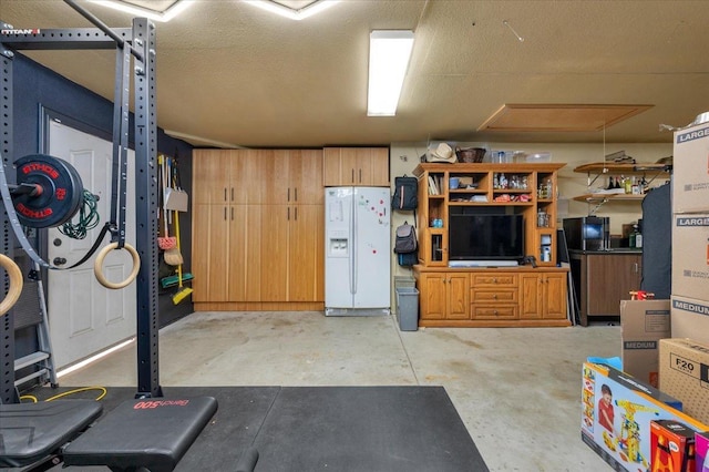 interior space with white refrigerator with ice dispenser