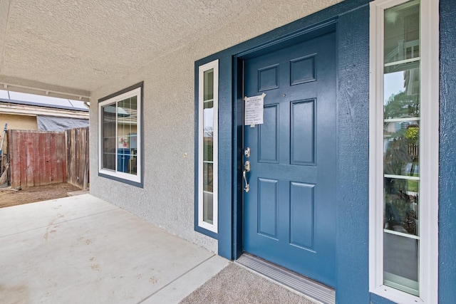 968 E Muncie, Fresno, CA 93720 - property entrance featuring covered porch, fence, and stucco siding