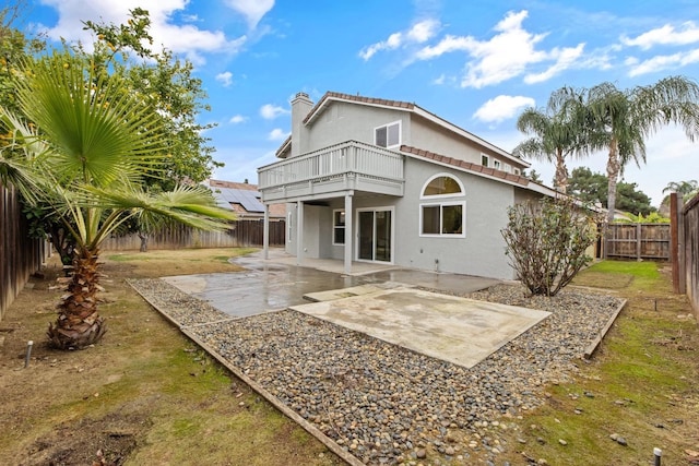 968 E Muncie, Fresno, CA 93720 - rear view of property featuring a balcony, a patio, stucco siding, a fenced backyard, and a chimney