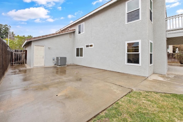 back of house with cooling unit and a patio area