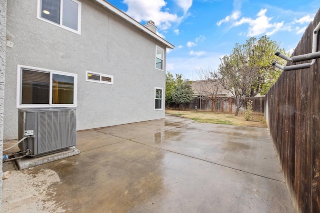 view of property exterior featuring central AC unit and a patio