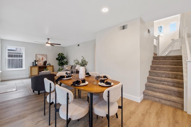 dining area with light hardwood / wood-style floors and ceiling fan