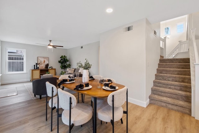 968 E Muncie, Fresno, CA 93720 - dining area featuring baseboards, ceiling fan, visible vents, stairs, and light wood-type flooring