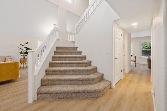 stairs featuring wood-type flooring