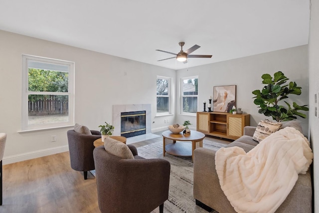 968 E Muncie, Fresno, CA 93720 - living area with baseboards, a wealth of natural light, a tiled fireplace, and wood finished floors