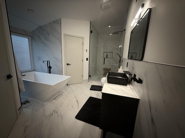 bathroom featuring vanity, separate shower and tub, and tile walls