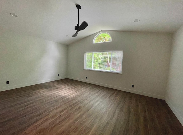 empty room featuring lofted ceiling, dark hardwood / wood-style floors, and ceiling fan