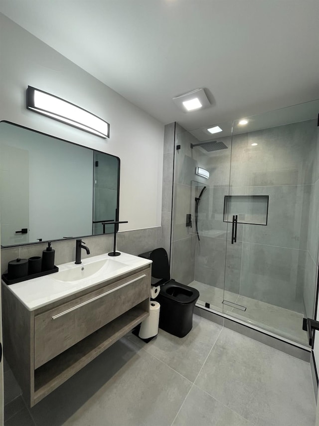 bathroom featuring vanity, tile walls, and walk in shower