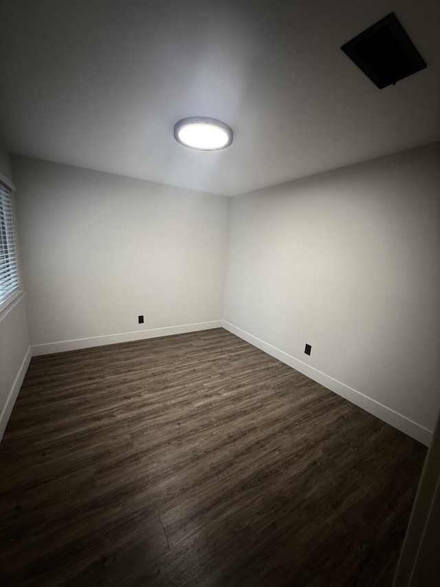 unfurnished room with dark hardwood / wood-style floors