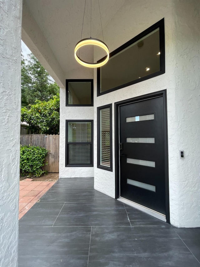 view of exterior entry featuring a patio area