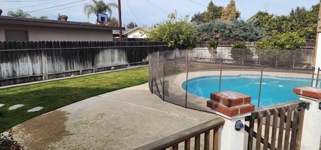 view of pool with a yard