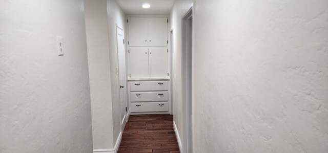 hallway featuring dark hardwood / wood-style flooring