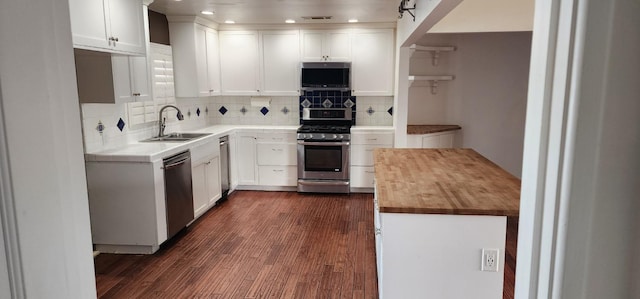 kitchen with white cabinetry, appliances with stainless steel finishes, and wooden counters