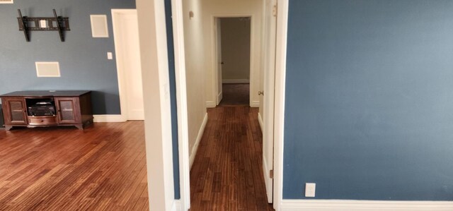 hallway with dark wood-type flooring