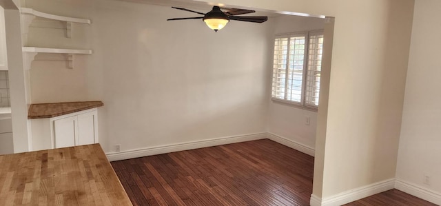 unfurnished room with ceiling fan and dark hardwood / wood-style flooring