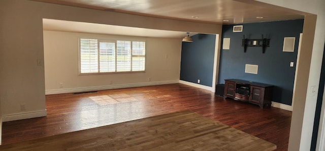 unfurnished living room with dark hardwood / wood-style flooring