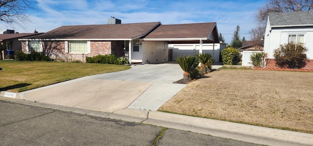 ranch-style home featuring a carport and a front lawn